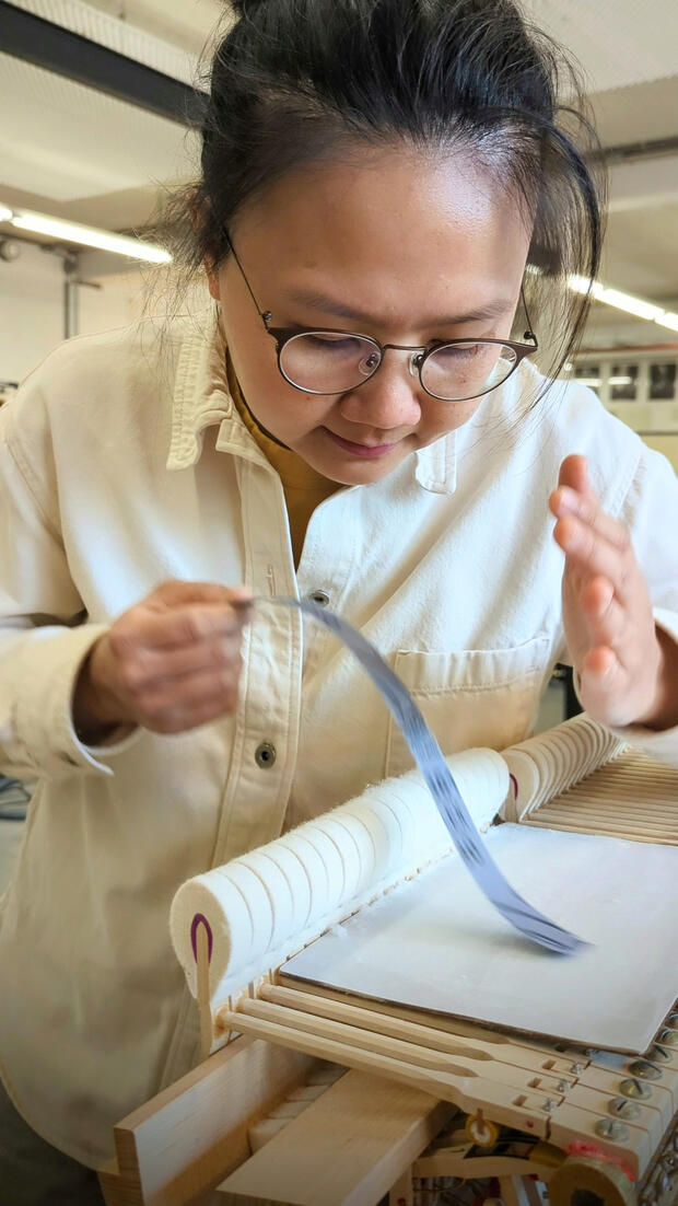 Sanding hammerheads. Khai is shaping the hammerheads to have a better point of contacts to the strings.