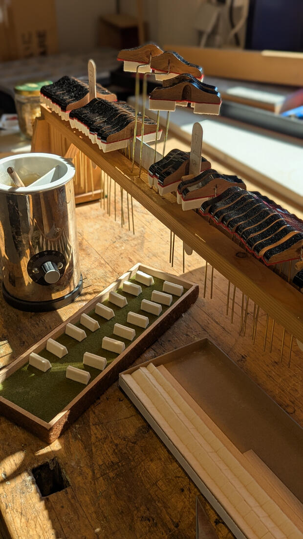 Steinway damper felt installation uses traditional hot hide glue to bond genuine felts for a superior, reversible bond. This authentic piano restoration technique ensures immediate string termination and meets the original factory standards of a Steinway &